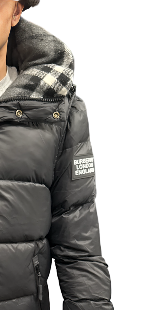 Premium authentic Burberry puffer jacket featuring the iconic “Burberry London England” sleeve patch and signature check-lined hood. This is a single resale item in excellent condition.
